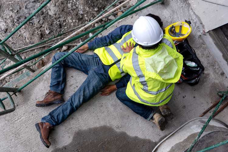 two workers one is injured lying unconscious 
