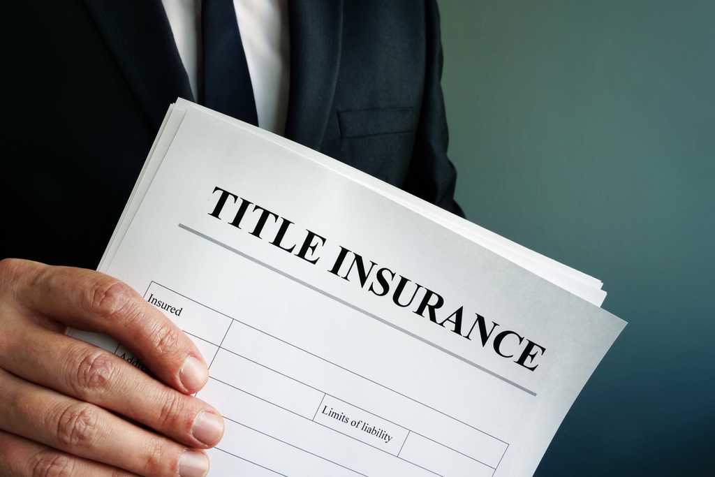 Title Insurance agreement in the hand