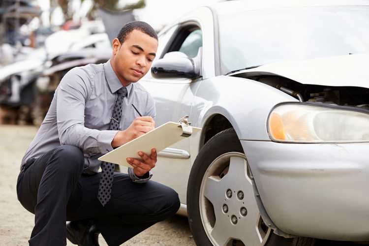 insurance adjuster inspecting car