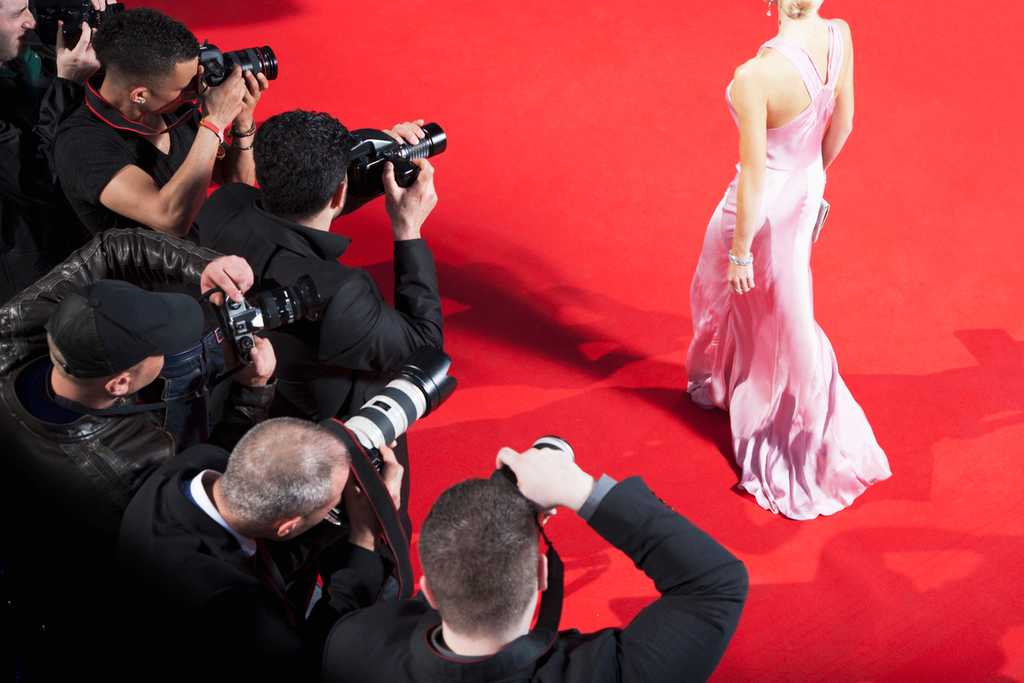 paparazzi's taking picture of famous person on red carpet 